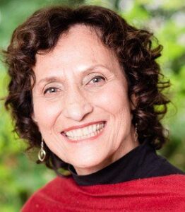 Smiling woman with curly hair and earrings