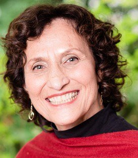 Smiling woman with curly hair and earrings