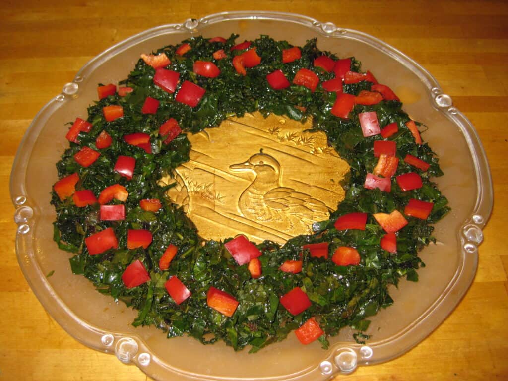 Collard greens and peppers on a decorative plate.