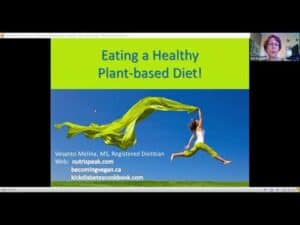Woman jumping with a green cloth outdoors promoting plant-based eating.