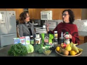 Two women discussing healthy foods in kitchen.