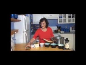 Woman preparing ingredients in kitchen, cooking setup.