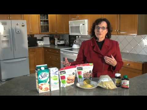 Woman discussing various health products in kitchen.